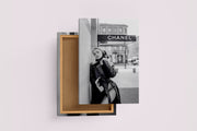 a black and white fashion photo of a woman posing under a chanel sign, art, kanvas tablo