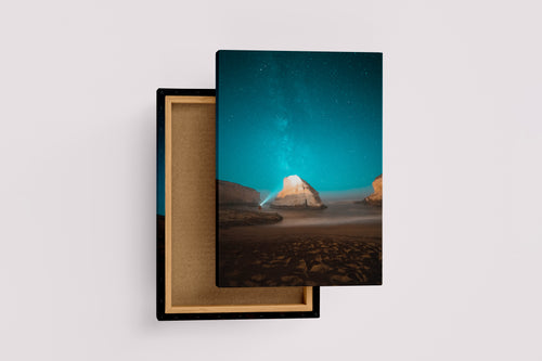 a man on a beach at night, illuminating a sea stack under the milky way, art, kanvas tablo