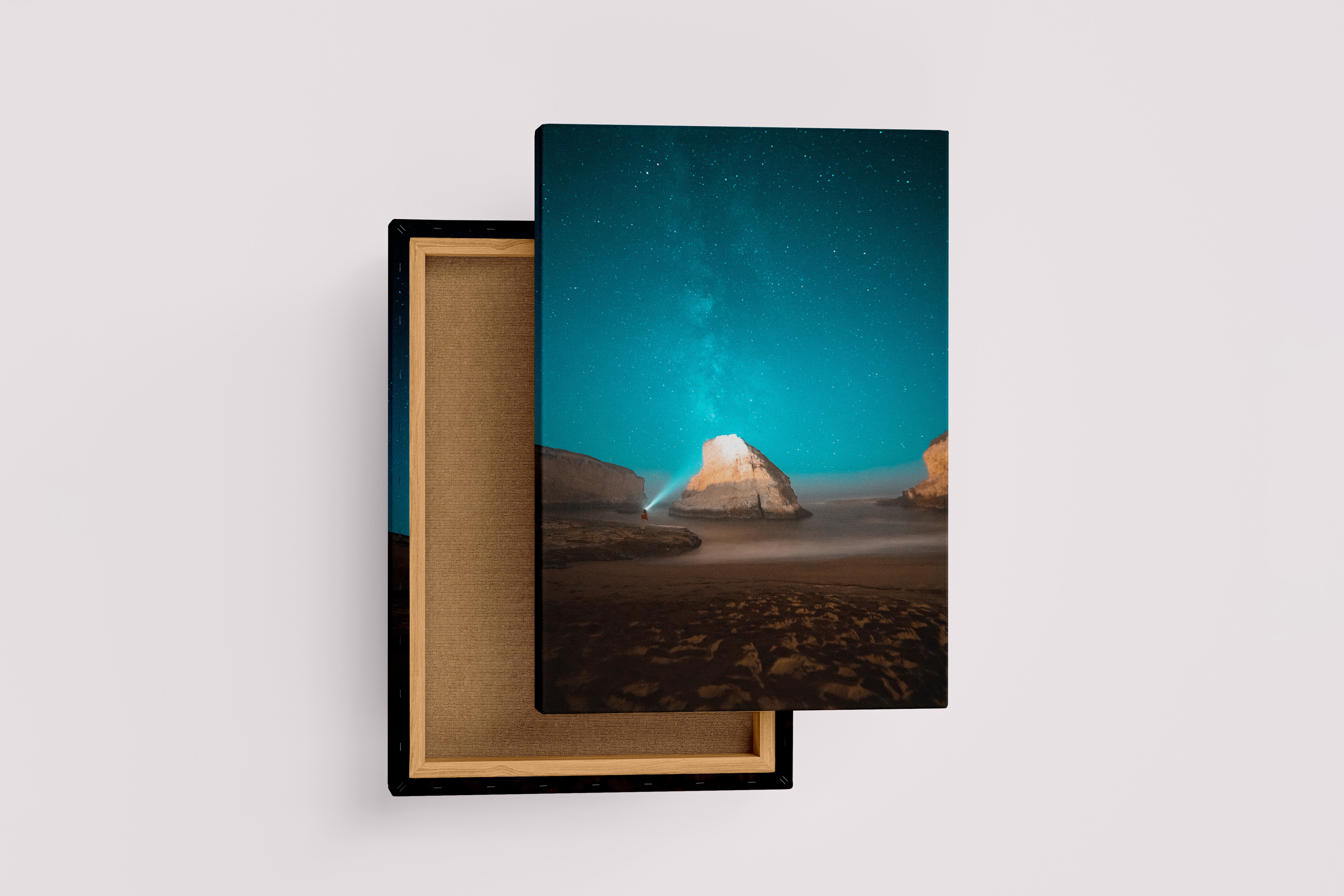 a man on a beach at night, illuminating a sea stack under the milky way, art, kanvas tablo