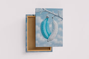 ai creation, white and blue banana hanging on a branch, winter themed, art, kanvas tablo