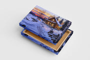 footprints in the snow lead to a cozy cabin glowing at sunset, view, art, kanvas tablo