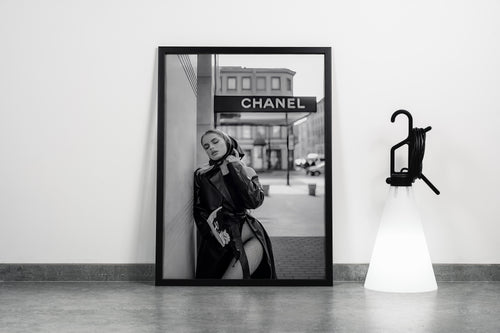 a black and white fashion photo of a woman posing under a chanel sign, art, kanvas tablo