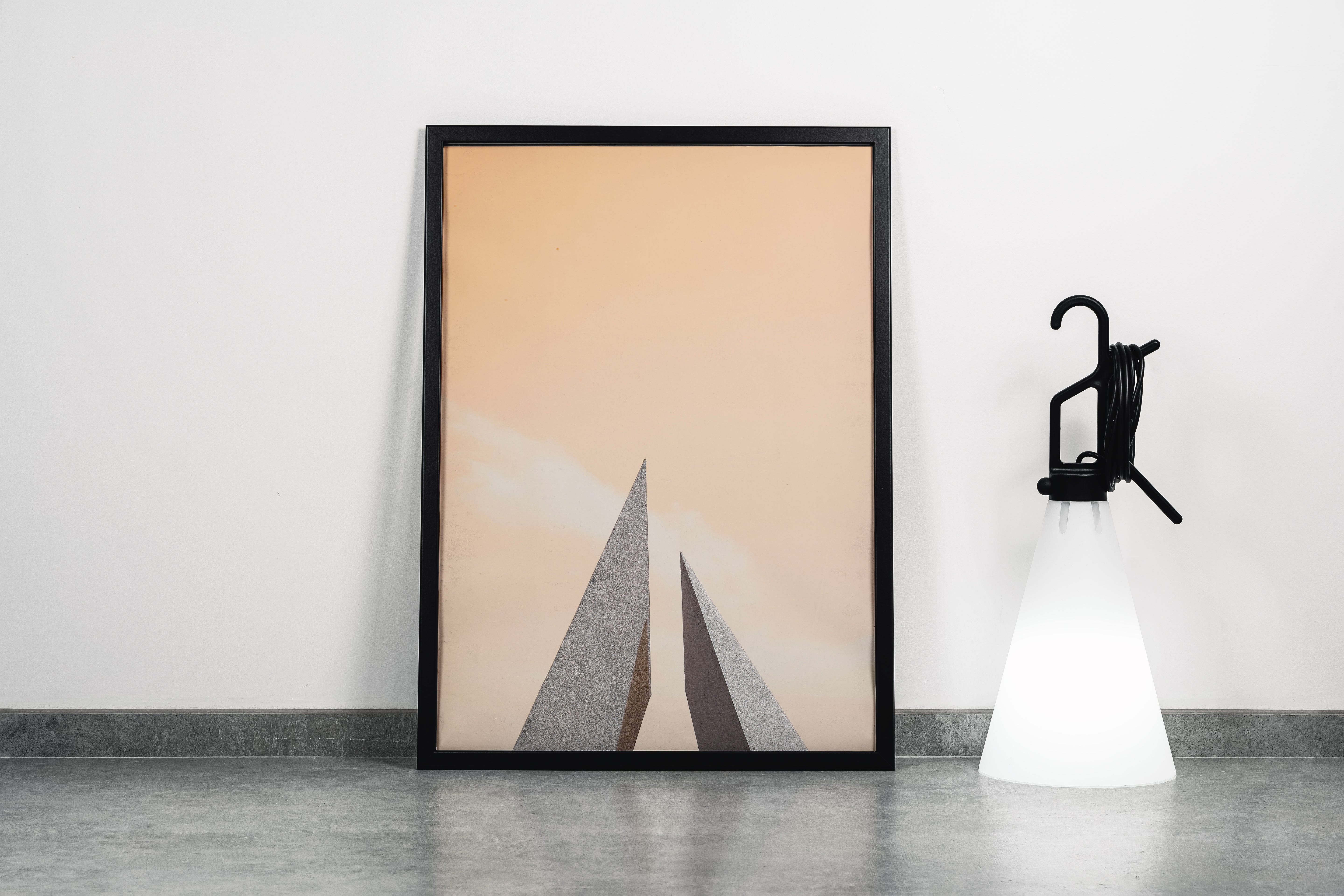 minimalist architectural photo of two sharp triangular structures against a warm pastel sky, abstract, art, kanvas tablo