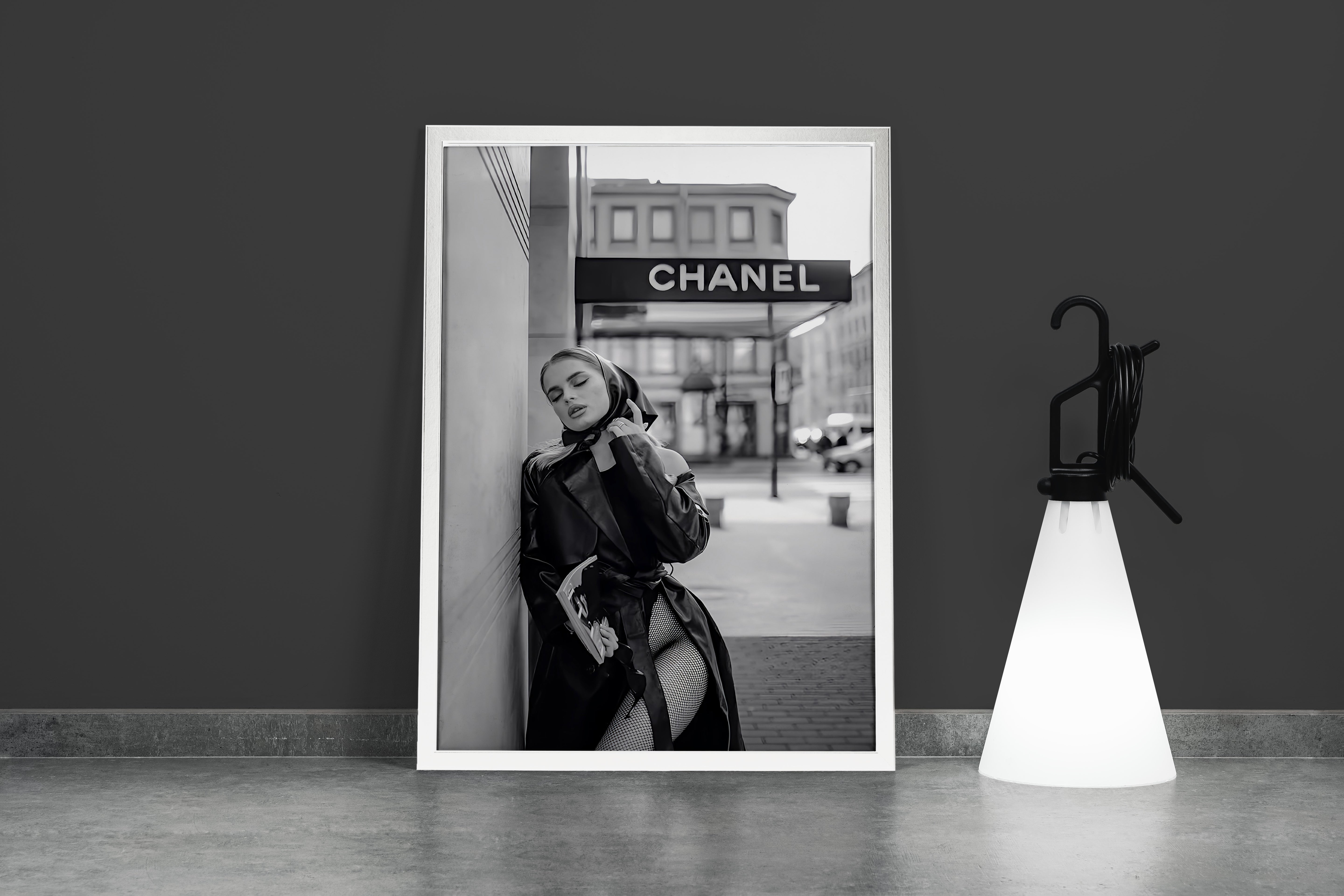 a black and white fashion photo of a woman posing under a chanel sign, art, kanvas tablo