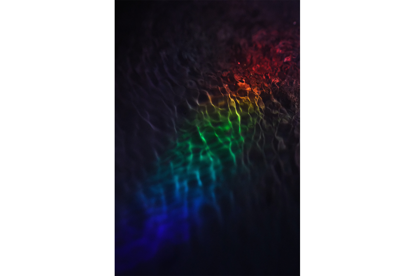 a subtle and dark photograph of rainbow-colored light refracting on gentle water ripples, abstract, art, kanvas tablo