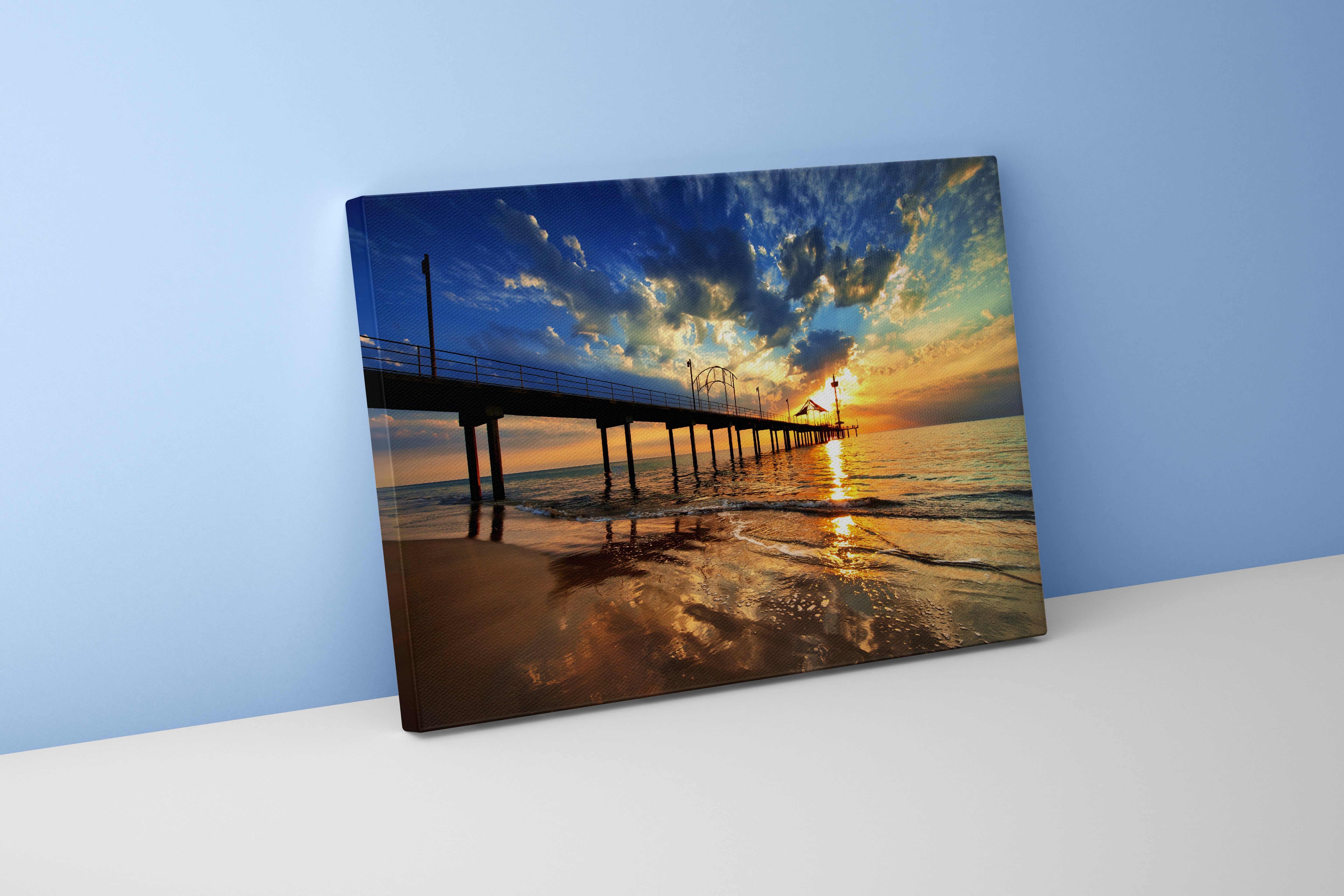 a pier on a beach under a dramatic sunset with golden reflections, view, art, kanvas tablo