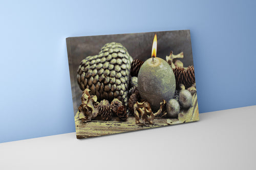 a cozy, rustic winter display with a lit candle, pinecones, and a heart, art, kanvas tablo